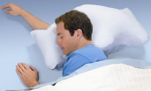 a man sleeping on a stop snoring pillow